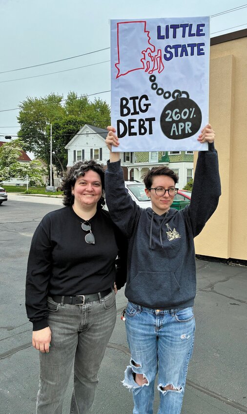 Peggy Desjarlais (L) standing next to a the sign holder who did not provide her name.