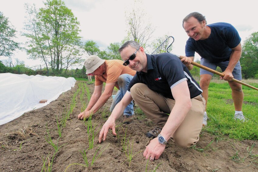 Farming can always use a little bit of scratching here and there. Tom Sanford and his son, Chris, plant onions while former club member Tim Hudyncia,  who stopped by to say hello, had some fun. Beacon Media photos by John Howell