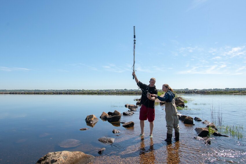 The University of Chicago&rsquo;s Dr. Brian Prendergast and TNC&rsquo;s Heather Kinney try to get a satellite signal on the tide-covered causeway at Salter Grove in Warwick.