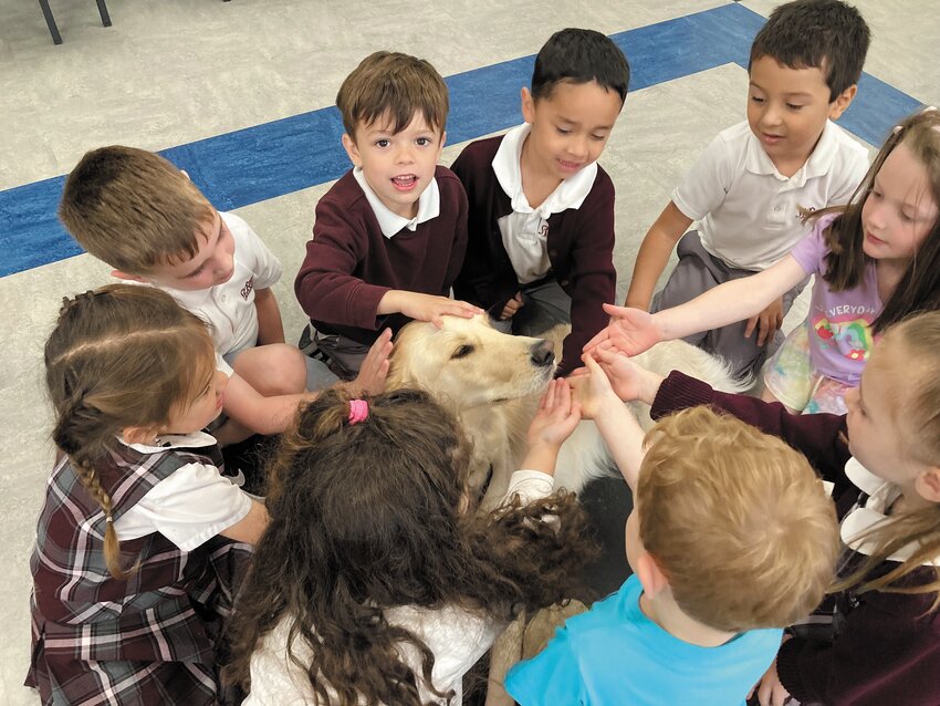 Students at St. Rocco School said their goodbyes to pet therapy dog Emerald on Monday in her final visit to the school this academic year. Pat Kane, Emerald&rsquo;s owner, used sessions with the dog to impart Catholic faith lessons to the children and teach them about the value of good character. Adored by younger students and eighth-graders alike, Emerald will be missed until her return in September.