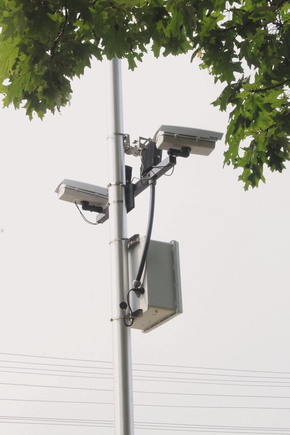 Against the backdrop of the Main and Greenwich Avenues intersection, where cameras have been installed to catch motorists who run red lights, Mayor Frank Picozzi announces the program designed to enhance safety and generate revenue. Beacon Media photo by John Howell