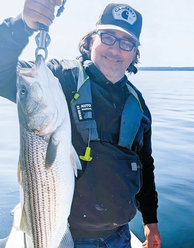 Personal best: Jason Mills of Cranston with the 39&rdquo; striped bass he caught Tuesday off Poppasquash Point, Bristol.