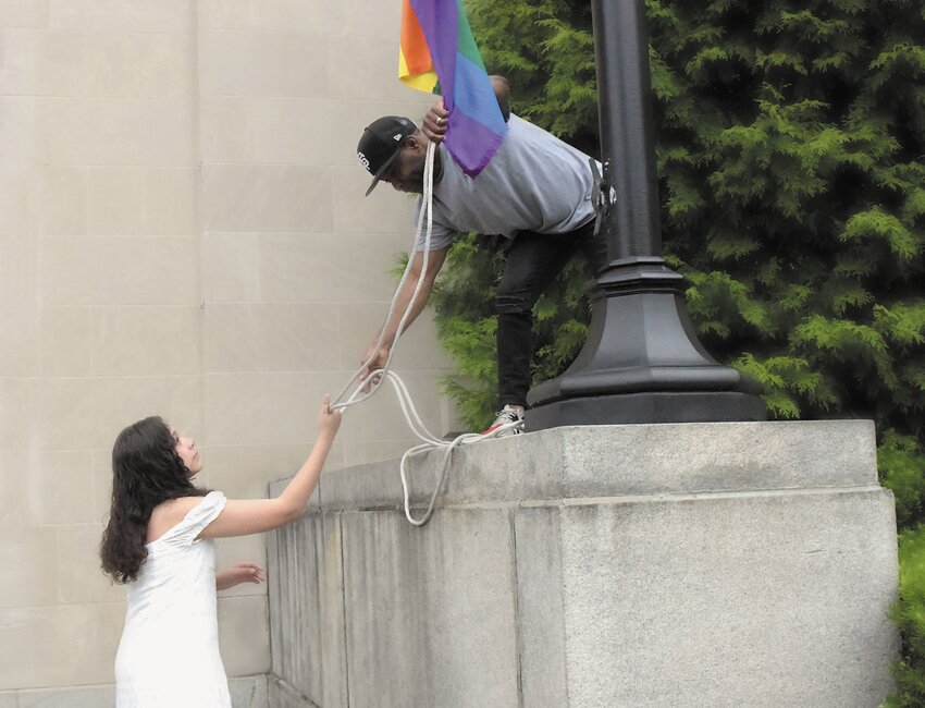 City Council members and other dignitaries held small rainbow-colored flags in a show of unity.