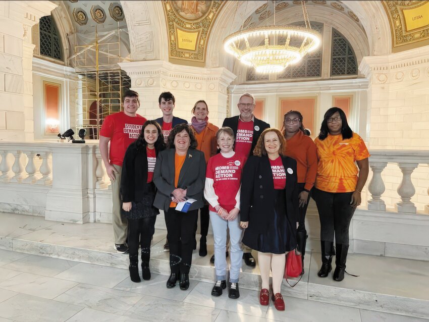 Rhonda Brewster, second from right, advocated alongside other activists at the State House for stricter gun storage laws following her son’s death.