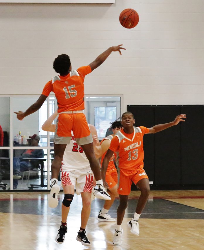 Yellowjacket Xzavien Lipscomb,15, elevates to deflect a pass during a back court press. Also pictured is Jamarcus Kennedy, 13.