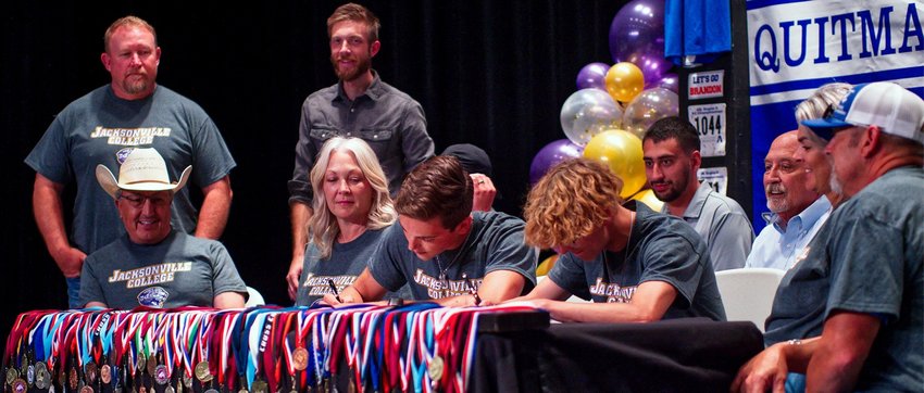 Brandon Jimenez and Jack Tannebaum of Quitman sign letters to compete in track at Jacksonville College.
