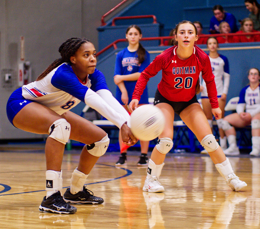Newcomer of the year, sophomore Allie Berry, handles a dig as first-team all-district teammate Addison Marcee awaits, Aug. 23 at home vs. Quinlan-Boles.