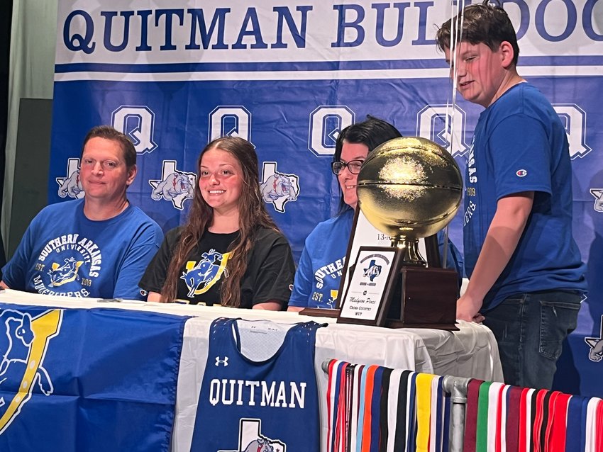 Quitman&rsquo;s Maddy Pence signed a letter of intent last Thursday to attend Southern Arkansas University where she will run cross country and track. She is pictured with her family (from left) father Shannon Pence, Maddy, mother Mishea and brother Allen.    Pence also played varsity basketball, volleyball and softball during her four years at QHS. Cross Country Coach Mike Scott said Pence was &ldquo;The foundation that helped build this program from just a few to over 30 girls who now are involved in cross country.&rdquo;