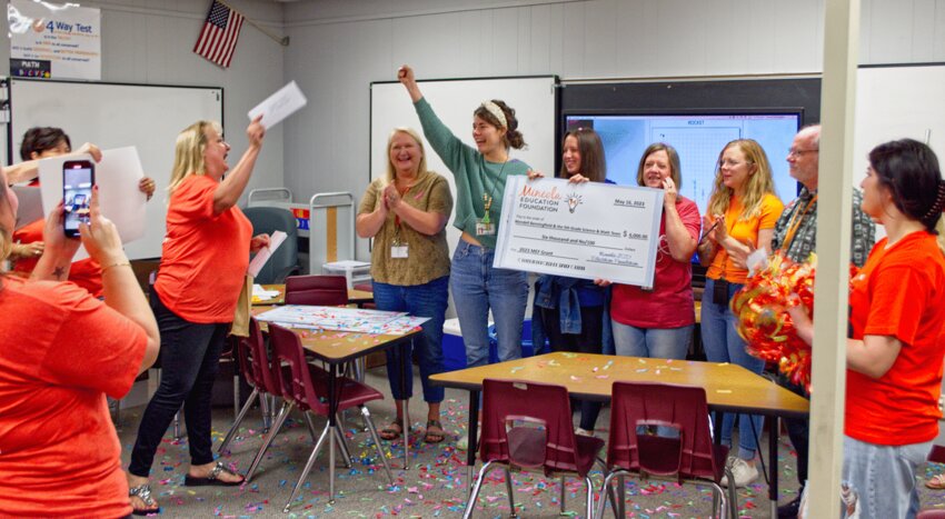 Mineola fifth grade teacher Madelyn Wood celebrates with fellow teachers, from left, Julie Conner, Wood, Kayla Henton, Laura Shook, Lacy Collum and Wendell Benningfield after Martha Holmes with the Mineola ISD Education Foundation presented a grant check for $6,000 Friday morning.