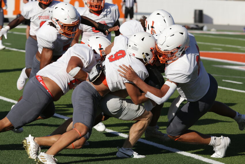 Mineola held its final scrimmage against Caddo Mills Thursday. Here, the Mineola defense swarms to the ball. Mineola opens the regular season Friday at Canton.