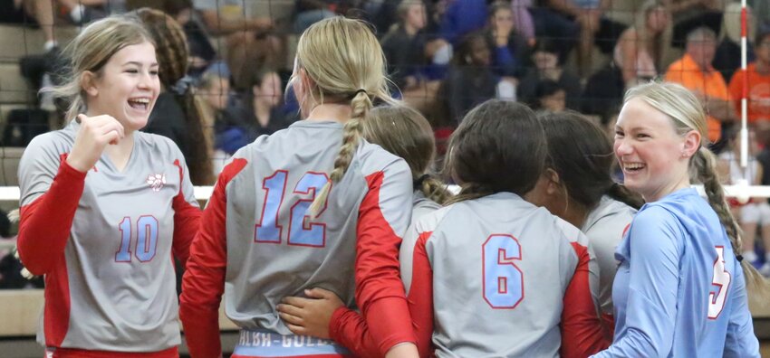Alba-Golden celebrates a first game win against Queen City. The faces of Lainey Teel (10) and Alyssa Murdock (5) aptly reflect the emotional win.