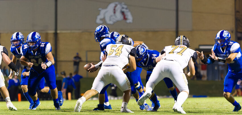 The Quitman offensive line clears a path.