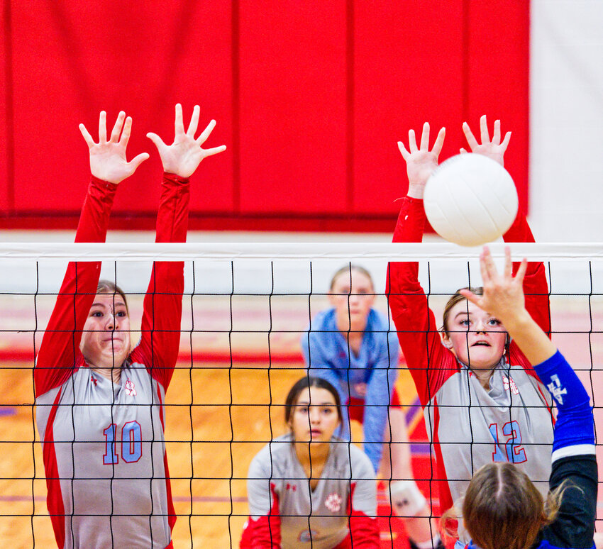 Lainey Teel and Alexis Wilmut defend the net in action against Frankston last Tuesday. Alba-Golden won 30-28, 25-16, 11-25, 28-26.