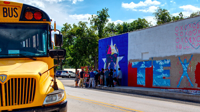 Quitman art students took a bus to the square downtown to learn from muralist Patrick McGregor, who created the art along the west-facing wall of Dani's Sidekick.