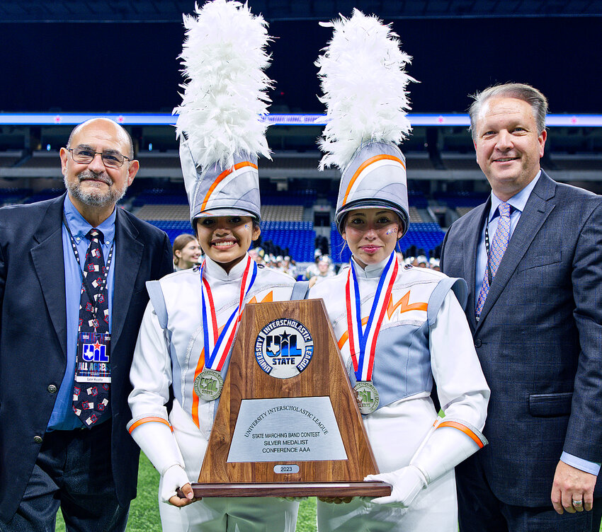 Mineola drum majors Marianna Delgadillo, left, and Jada Woodward are congratulated by UIL Assistant Music Director Gabe Musella, left, and Music Director Dr. Bradley Kent as the 2023 Conference 3A silver medalist in state marching.