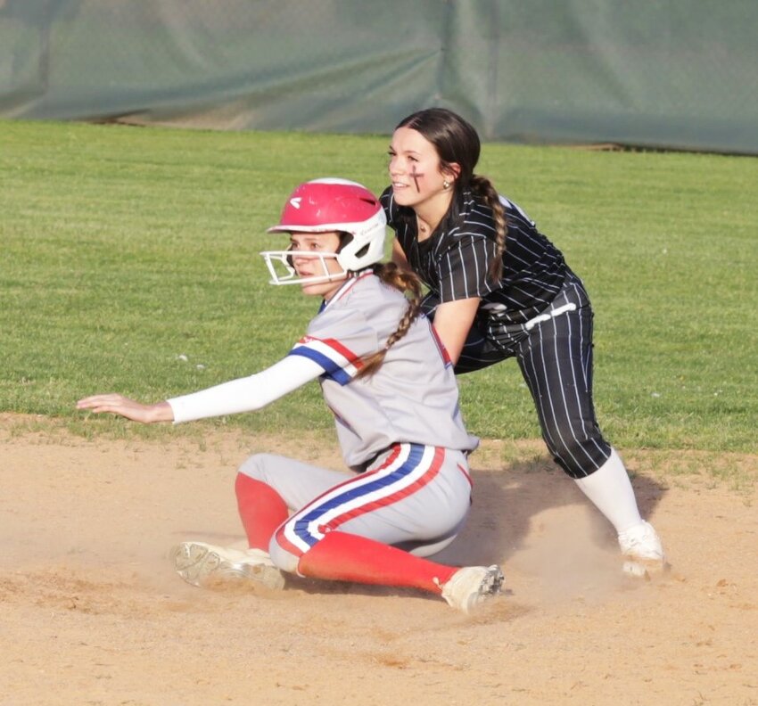 Senior Bailee Bishop stretched a single into a double against Como-Pickton. She was safe under the tag at second base. She and the Lady Eagle shortstop look to the umpire for the call.