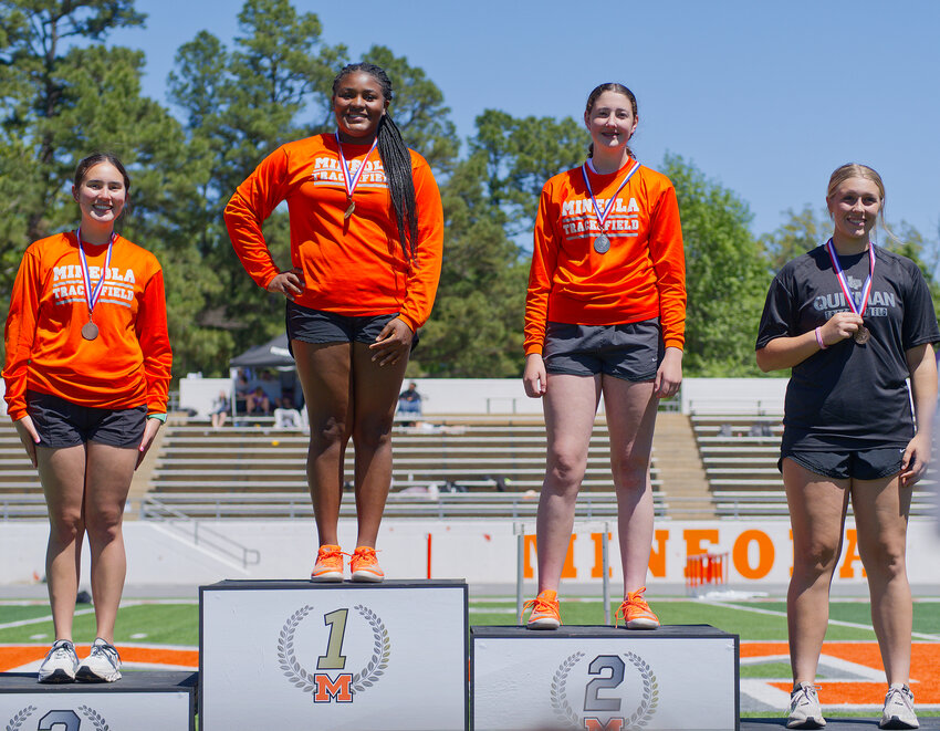 Left to right, Makena Quiambao, Zion Olajide, Callie Black and Annabelle Popek show off their newly acquired hardware. Olajide, Black and Quiambao swept the top three spots in the discus. Olajide threw 91 feet, with both of her teammates challenging that throw.&nbsp;Quitman's Popek claimed the fourth spot and an area meet berth.