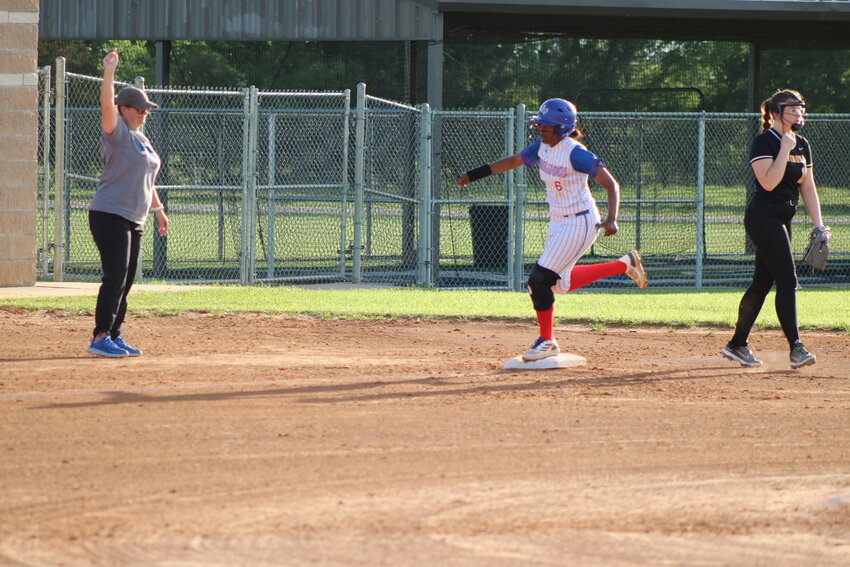 Allie Berry rounds third base with Coach Catie Glenn urging her on to home for an in-the-park home run.