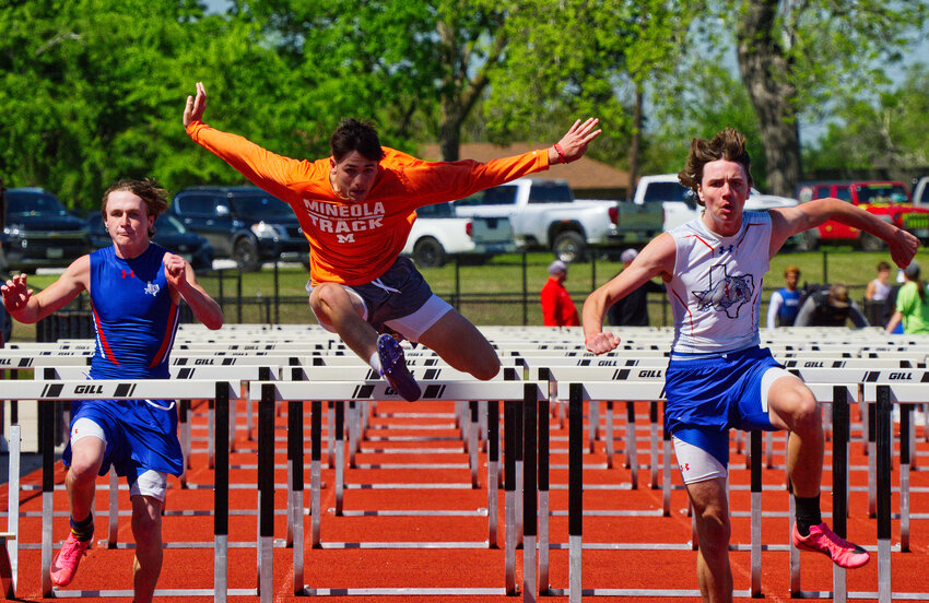 Caden Rupert (center) of Mineola and Quitman hurdlers Colden Wilson (left) and Bryson Hobbs (right) eye the finish line of the 110m hurdle race. [see more speed and strength on display]