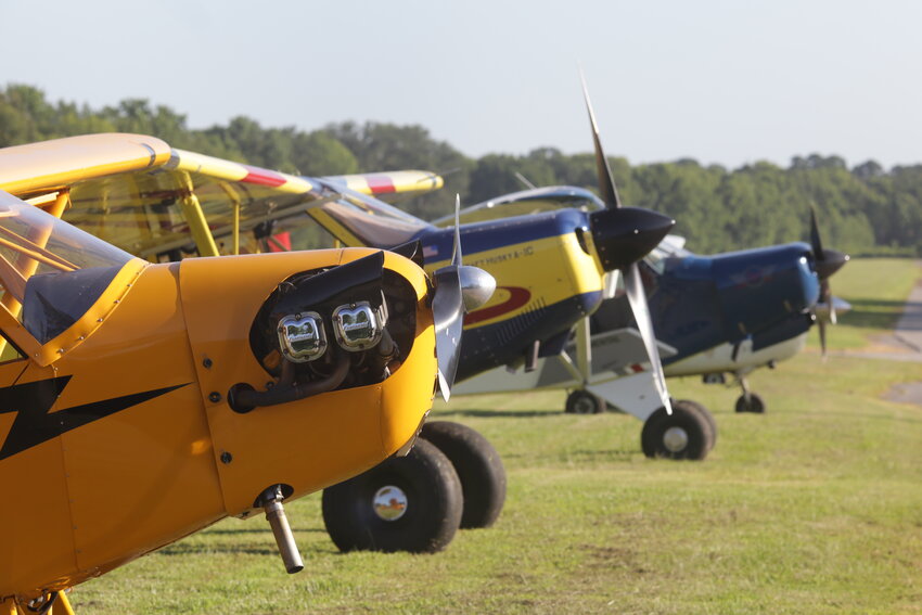 An array of colorful airplanes on the parking apron at Wisener Field for the 4th of July event.
