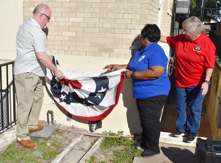 A new time capsule in the cornerstone of the Mineola Historical Museum was dedicated Monday, to be unveiled in 2073. Revealing the updated plaque are Landmark Commission Chairman Jimmy Philips, Museum Board President Novada Bigham and Mayor Jayne Lankford.