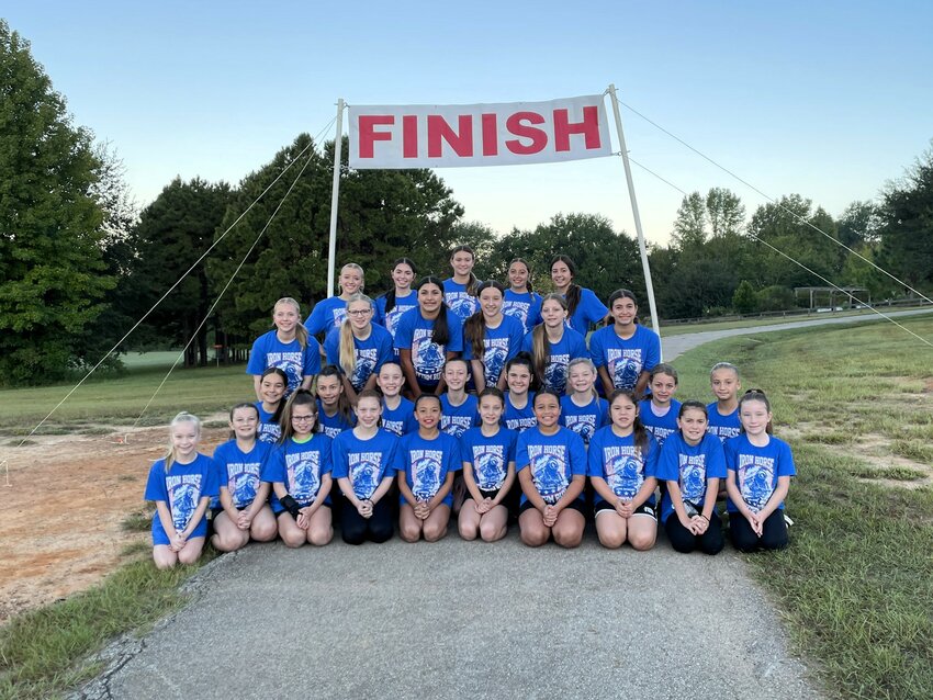 Dance Dimensions dancers competing in the annual Iron Horse Rhythm Run at the Mineola Nature Preserve Saturday, Sept. 28 gather at the finish line.