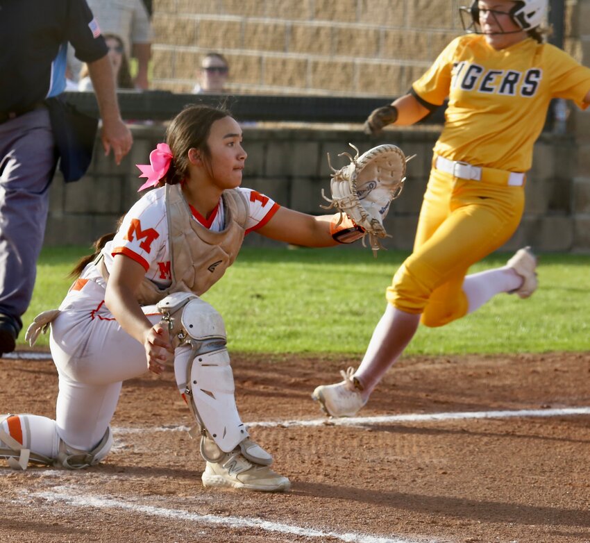 Lady Jacket Courtney Nguyen sets-up to take a throw at the plate early in the Malakoff game.