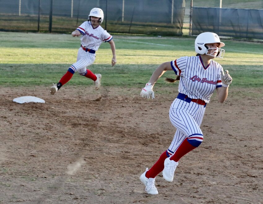 Lady Panther Piper Hallman leads teammate Jayla Sitar around the bases against Cumby.