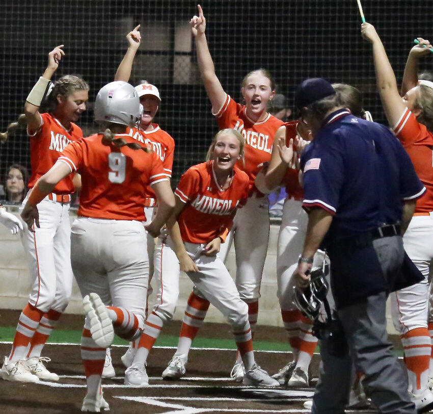 Kali Chrietzberg followed Journie Wilson’s home run with one of her own. She nears home plate as the team waits to congratulate her.