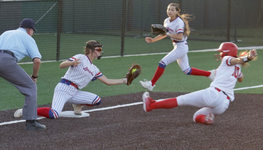 It appears that Alba-Golden had this Shelbyville baserunner cold, but she managed to avoid&nbsp;the tag on a close play. Joecey Lewers is covering the base with Piper Hallman coming in from the outfield to back-up the play.