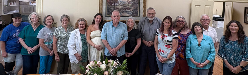 The staff at Grace Community Healthcare Clinic celebrates with volunteer Gay Morrow, right center, at her retirement reception recently.